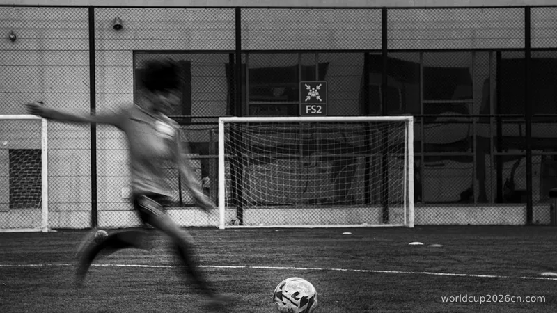 grayscale photography of person playing soccer ball