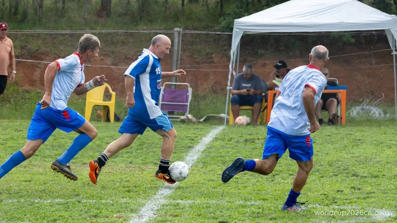 Men playing soccer on a grassy field