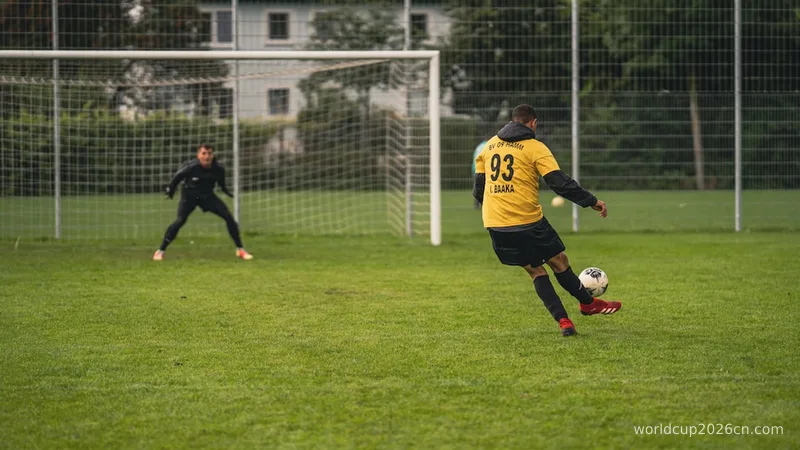 man in yellow and black soccer jersey kicking soccer ball on green grass field during daytime