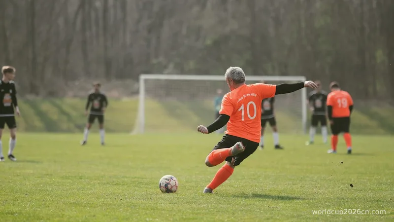 a man kicking a soccer ball on a field