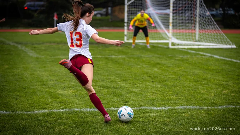 A female soccer player kicks the ball towards the goal.