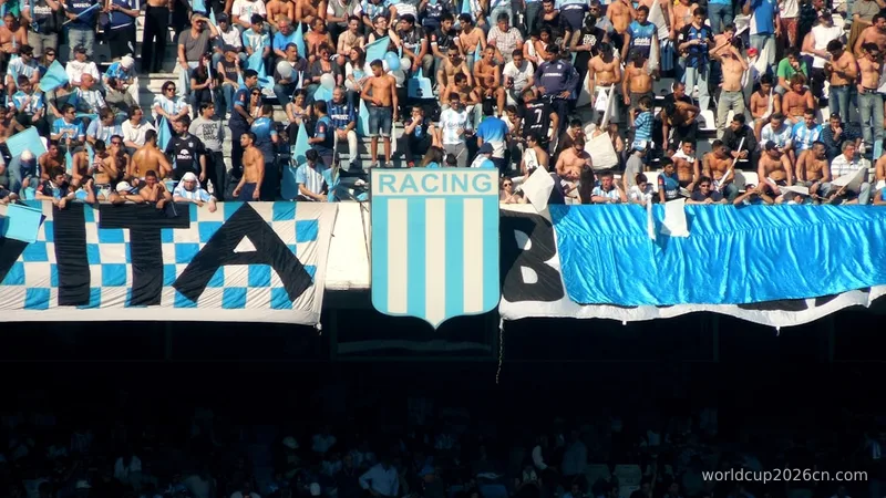 people in a stadium with blue and white curtains