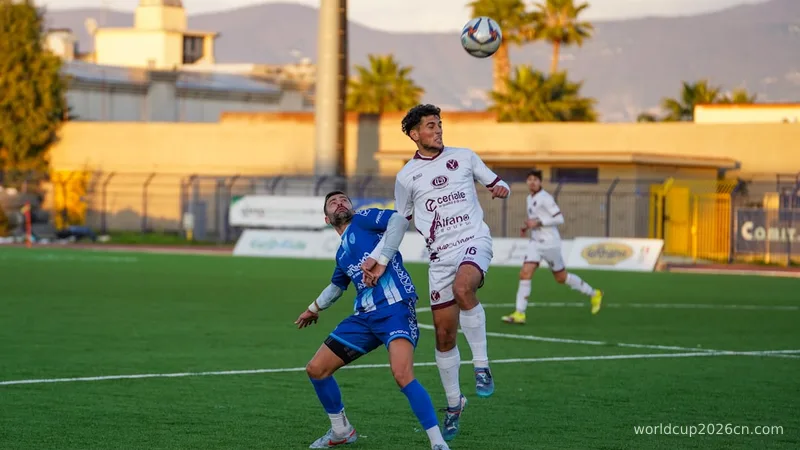Two soccer players jumping for a header