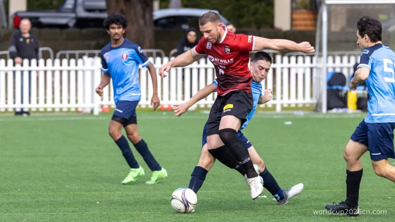 Soccer players competing for the ball on a field.