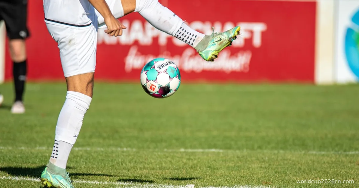 a man kicking a soccer ball on a field