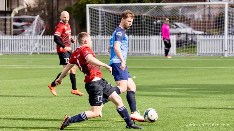 Soccer players competing for the ball on a field.