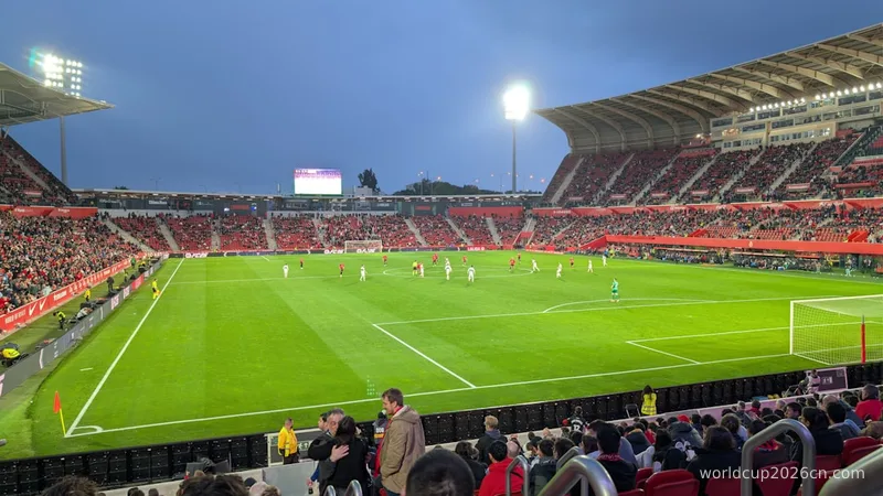 Soccer game in a stadium with spectators watching fans.