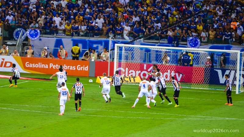 a group of soccer players playing a game of soccer