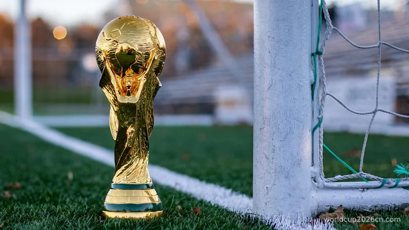 a golden soccer trophy sitting on top of a soccer field