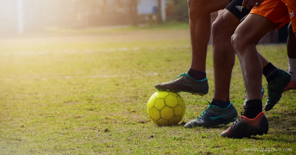 man in black shorts and black nike soccer ball on green grass field during daytime
