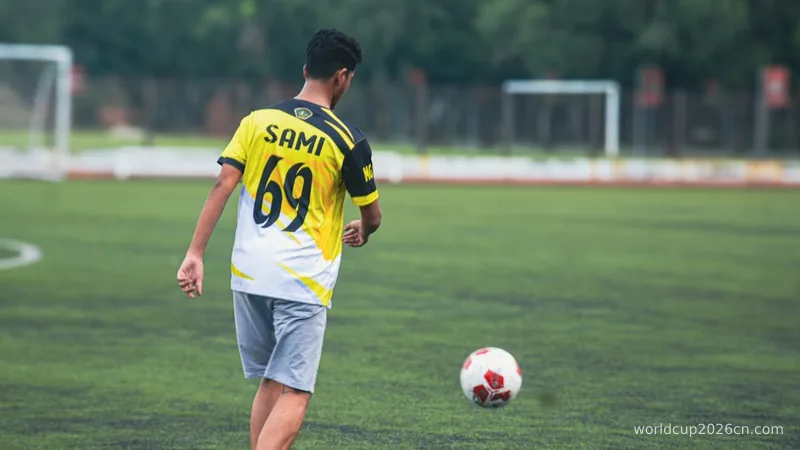 A young man playing soccer on a field.