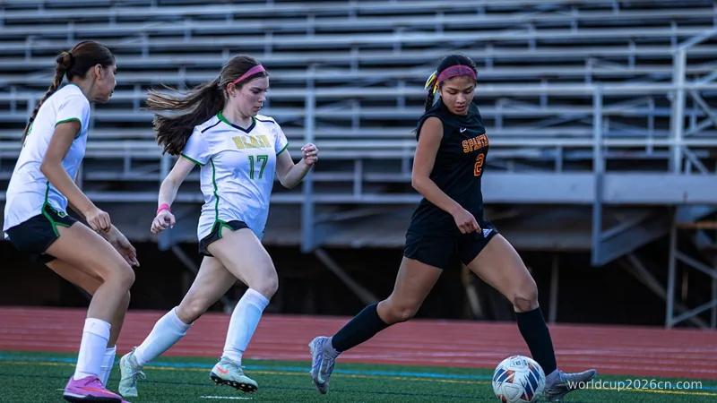 Young women playing soccer on a field