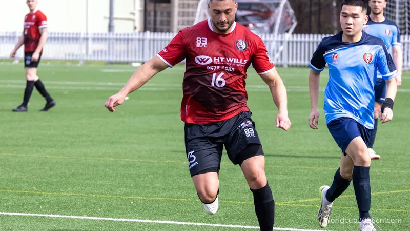 Soccer player dribbling ball on green field
