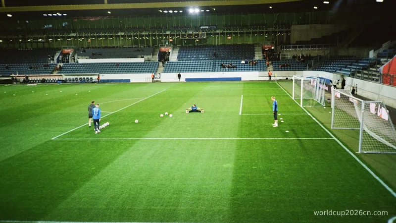 Soccer players prepare on the pitch.