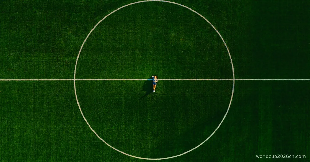 person in black shirt and black pants standing on green field