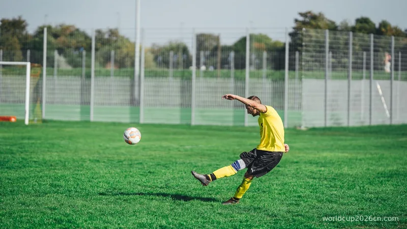 man in yellow shirt and black shorts playing soccer during daytime