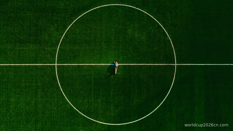 person in black shirt and black pants standing on green field