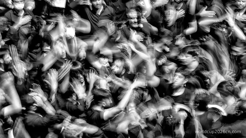 a crowd of people with their hands in the air